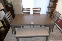 Full dining set including table, leaf, chairs, and bench