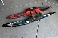 HO Sports competition water ski with double high-wrap boots and carrying bag on floor