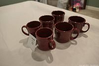 Photo showing all six paprika mugs arranged in two rows with handles facing outward.