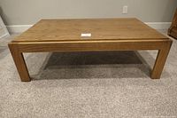 Front view of rectangular oak coffee table showing solid wood construction and leg design.