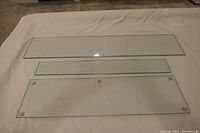 Three plate glass shelves displayed flat on white surface, showing the longest shelves with clear and clean appearance.
