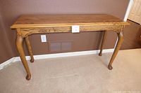 Front view of solid oak Parsons table showing Cabriole Queen Anne legs and wood grain detail on tabletop and apron.