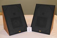 Pair of black-fronted Spica TC-50 stereo speakers showing front with black speaker cloth and badge
