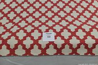 Close-up of the upholstery fabric showing red and cream geometric pattern and a MaxSold label with number 59.