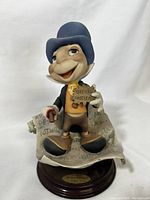 Front view of Jiminy Cricket statue showing detail and colors