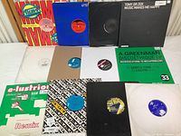 Overview of all 12 vinyl records with sleeves, showing variety of designs and colors