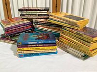 All 43 books shown stacked and spread, mostly vintage fantasy paperbacks by Lin Carter including series and individual titles.