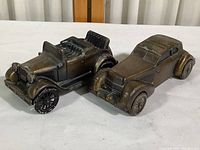 Both coin banks shown together, highlighting size and overall condition.