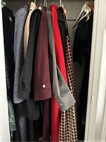 View of hanging various vintage wool and suede coats showing a range of colors and fabrics