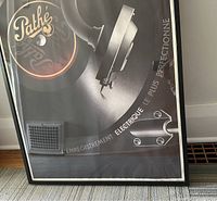 Framed Pathe print close-up showing the turntable, tonearm, and Pathe logo with text in French.