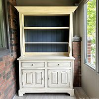 Front view of assembled two-tier buffet showing painted finish and overall shape