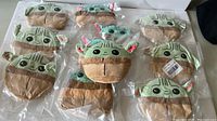 Photo showing 10 mini Yoda plush toys in clear bags showing details and packaging.