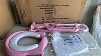 New pink ladder potty trainer parts including ladder and cushioned white seat with pink frame, packaging box in background.