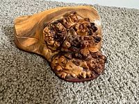 Close-up of the burl wood top surface showing textured natural knots and grain
