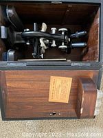 View of vintage Spencer microscope inside original wooden storage box with hinged lid, showing condition and placement.