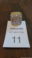 Front view of Denver Broncos Super Bowl 50 replica ring showing large '50' and team logo with rhinestone decoration.