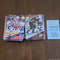 Two stacks of hockey cards from the 1993 Leaf series, showing cards with images of players Tony Amonte and Shayne Corson in their team uniforms on the front.