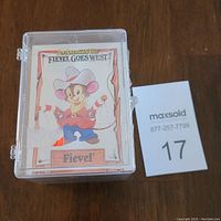 Top view of transparent plastic case with cover card showing cartoon character Fievel dressed as a cowboy from the 1991 film Fievel Goes West.