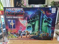Front view of unopened Masters Of The Universe Castle Grayskull playset box with colorful artwork showing castle and characters, selling price tag visible.