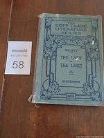 Front cover of the book with title, author, series, and publisher details visible. Shows wear and fraying on spine and corners.
