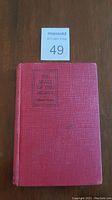 Full front cover of the red hardcover book "The Seats of the Mighty" by Gilbert Parker showing wear and title.