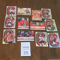 Top view of 13 Tim Hortons 2021-22 hockey cards spread out, featuring players in red and white uniforms including goalies and team captains.