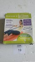 Box front of Gaiam CorePlus Reformer showing product features and workout DVD.