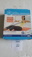 Boxed Gaiam CorePlus Reformer showing front cover with exercising model and feature details including workout DVD with Mari Winsor and resistance bands included.