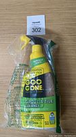 Front view of yellow Goo Gone Grout & Tile Cleaner spray bottle in original sealed plastic wrapper showing branding and product label.