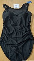 Front view of black high neck Summer Mae one-piece swimsuit showing solid fabric with ruched sides.