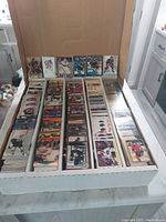 Box of approximately 4,000 hockey cards organized inside, showing varied hockey player cards and team logos in near mint condition.