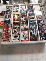 Photo of white box filled with rows of hockey cards, showing multiple cards organized upright.