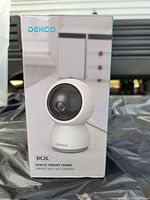 Photo of Dekco DC2L camera box front showing image of white spherical smart home WiFi camera.