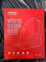 Front view of the red and white MPOW HC5 Bluetooth headset box showing headset image, brand, and model information.