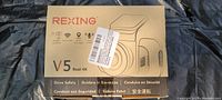 Front view of the Rexing V5 dash cam box showing brand, model, and resolution.