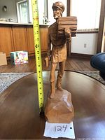 Full height view of the figurine with measuring tape showing approximately 17.5 inches tall.