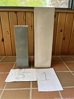 Photo showing two rectangular pottery floor vases side by side with paper labels 5 and 1 for scale/reference.