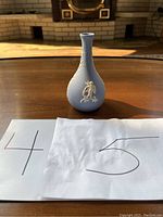 Front view of the Bud Vase showing the white cherub figure against a blue jasperware background