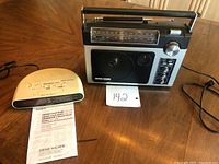 Sony Dream Machine AM/FM clock radio alongside General Electric portable AM/FM radio with seller's note