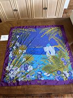 Full photo of large square silk scarf with ocean and sea life design in blue, purple, and green shades