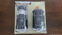 Packaged set of two Adventure Ridge LED pop up lanterns with batteries included, one expanded and one collapsed