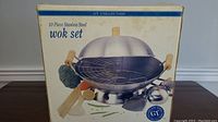 Box front showing the GT Collection 10-piece stainless steel wok set with wok, lid, wire rack, and accessories.