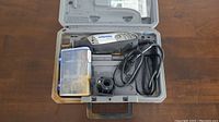 Dremel 3000 rotary tool inside carrying case with accessory kit and power cord.