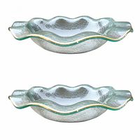 Two frosted glass bowls with wavy gold trim shown from side angle to highlight form and texture.