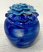 Side view of the blue ceramic ginger jar showing the rounded body and glossy glaze.