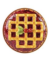 Top view of the ceramic pie dish lid, showing detailed hand painted lattice crust with cherries and leaf.