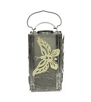 Metal butterfly lantern with clear glass panels and beige butterfly designs, featuring a metal handle on top.