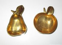Photo showing brass apple and pear candy dishes with polished interior and leaf detail
