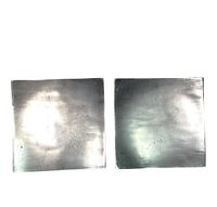 Two square silver chrome modern abstract plates side by side on white background showing reflective surfaces and condition