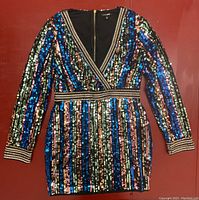 Front and back view of the large size Fashion Nova rainbow sequin dress with long sleeves and a zipper.